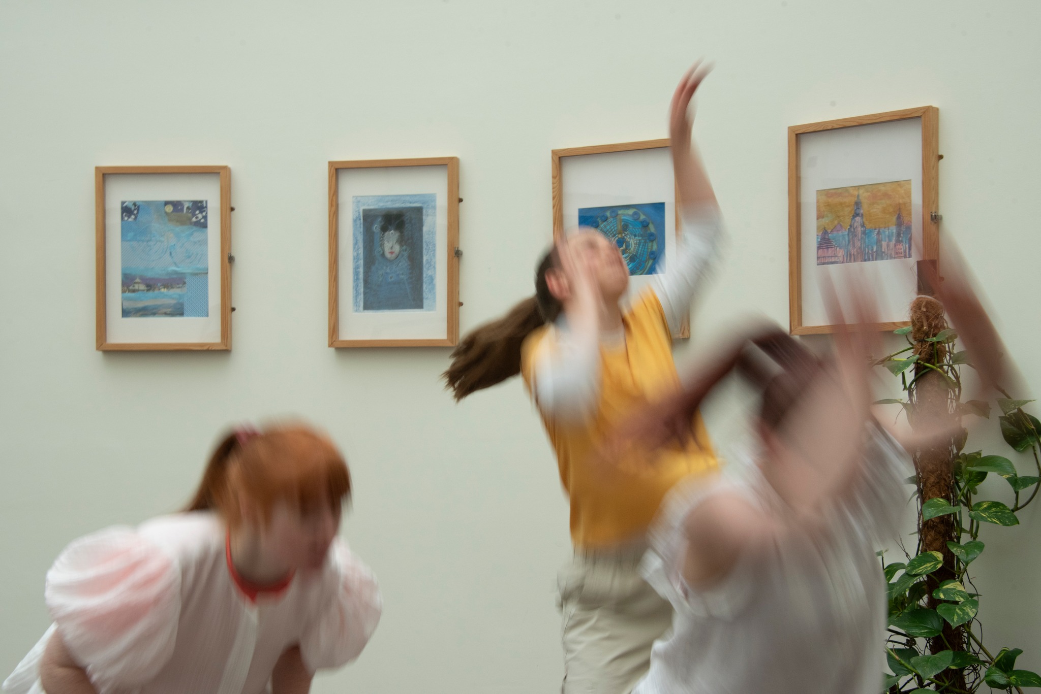 three dancers blurred in motion